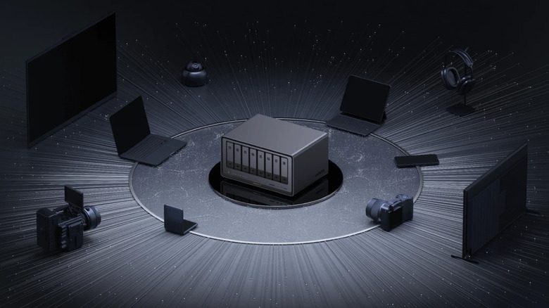 Product image of Ugreen NAS surrounded by laptops and cameras.