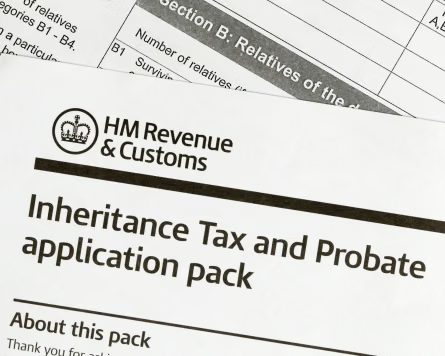 Closeup of overlapping HM Revenue and Customs forms titled Inheritance Tax and Probate application pack