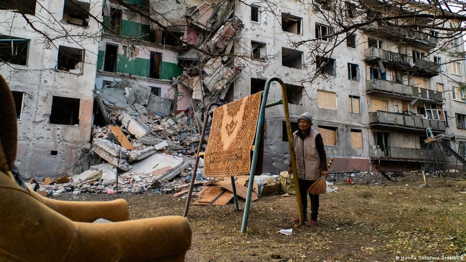 Tetjana stands near her apartment building in Sloviansk which was damaged by a Russian aerial bomb 
