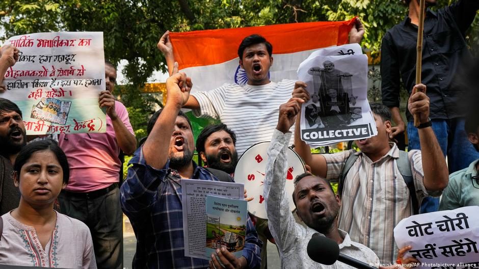 A banner with a portrait of Elon Musk is carried during a protest in New Delhi