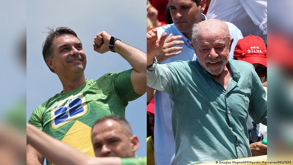 Flavio Bolsonaro and his wife Fernanda make V-for-victory signs at a polling station in Rio de Janeiro