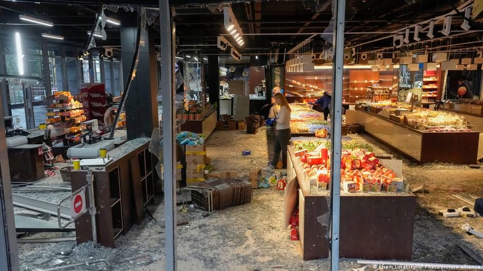 A police officer inspects the site of a fitness club building hit by a Russian missile strike,