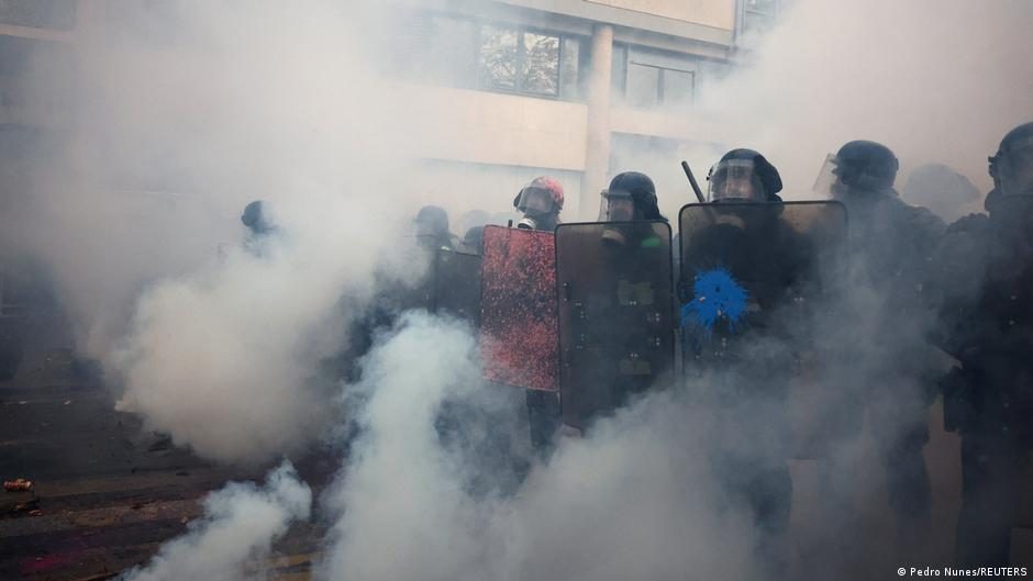 Riot police wielding shields move through a street in Paris (24 October 2026)